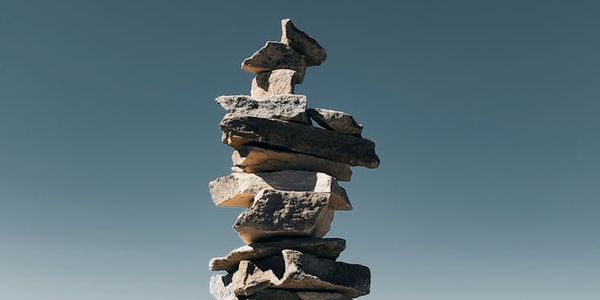 A simple natural object, like a stack of stones, symbolizing balance.